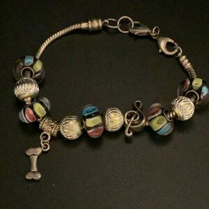 Charm bracelet - glass beads, silver dog bone, treble clef. - 8.5”
